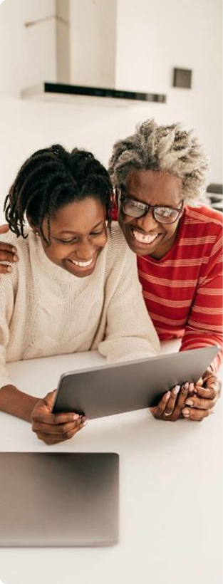 Duas mulheres sorrindo enquanto usam um tablet